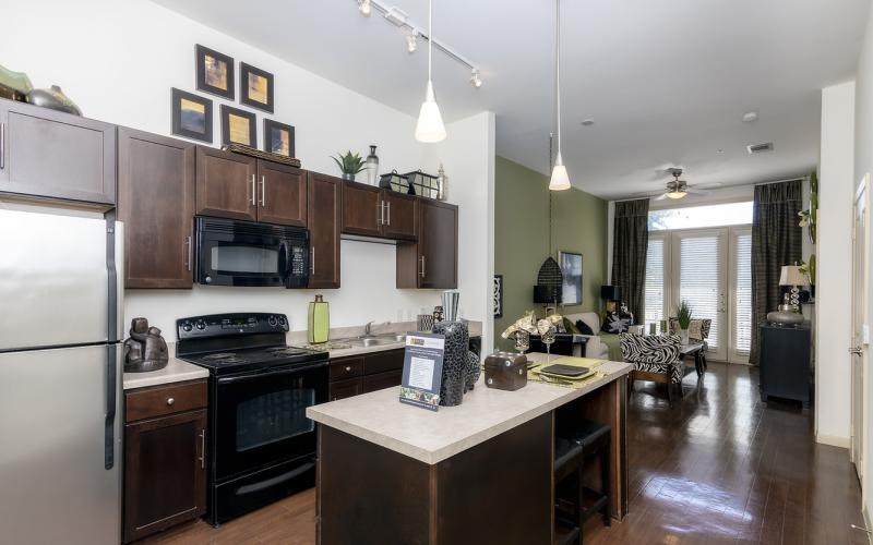 a kitchen with a bar and a dining table